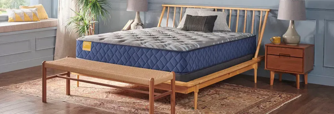Sealy queen mattress on a wooden bed frame showing proper support for mattress maintenance.